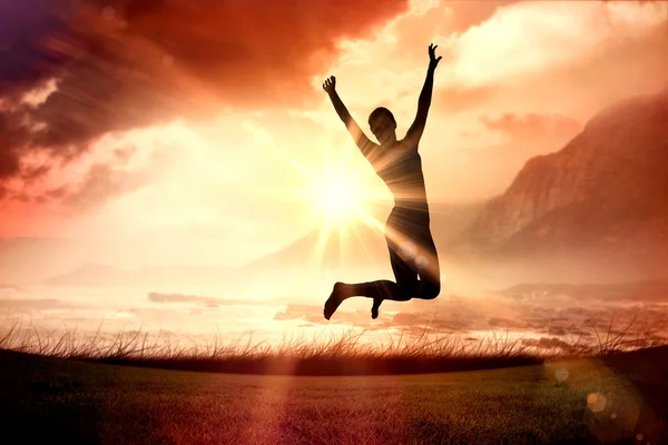 Woman jumping with arms out — Stock Photo, Image
