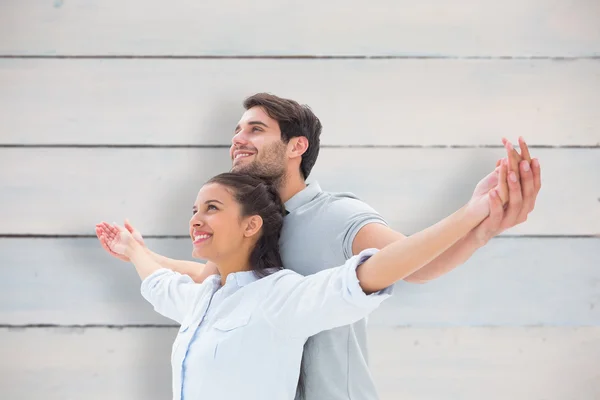 Cute couple standing with arms out — Stock Photo, Image