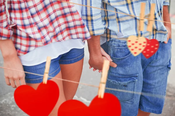 Couple in check shirts and denim holding hands — Stock Photo, Image