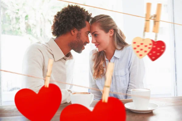 Couple on a date against hearts — Stock Photo, Image