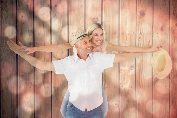 Man giving his partner a piggy back — Stock Photo, Image