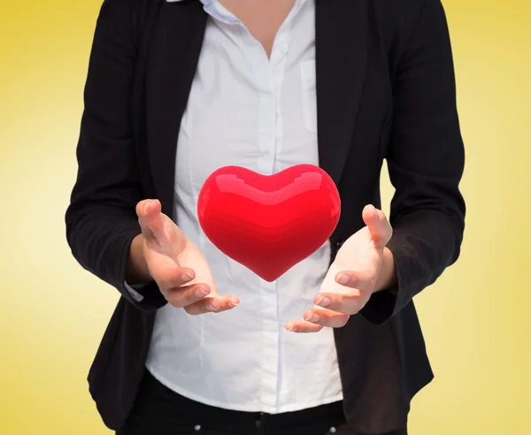 Businesswomans hands presenting heart — Stock Photo, Image