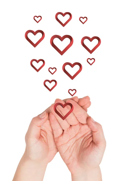 Hands presenting hearts — Stock Photo, Image