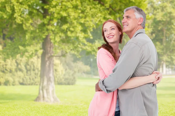 Couple hugging against trees and meadow — Stock Photo, Image