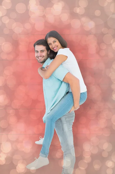 Man giving pretty girlfriend piggy back — Stock Photo, Image