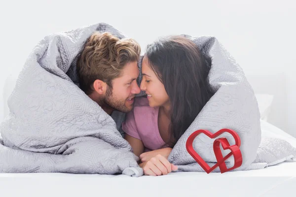 Couple wrapped in the duvet — Stock Photo, Image