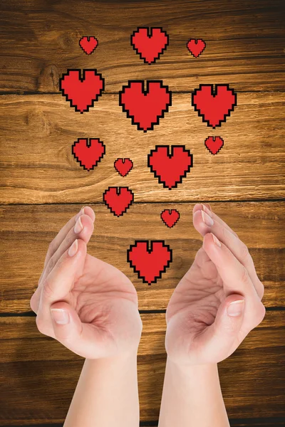 Hands presenting hearts — Stock Photo, Image