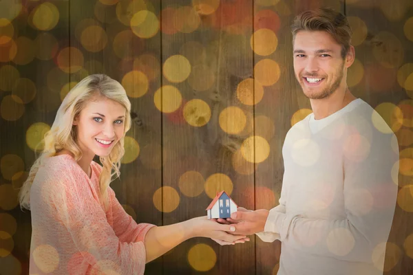 Couple holding miniature house model — Stock Photo, Image