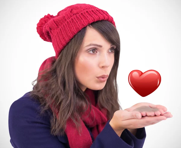 Festive brunette blowing over hands — Stock Photo, Image