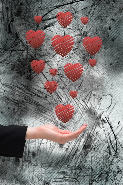 Businesswomans hand presenting hearts — Stock Photo, Image