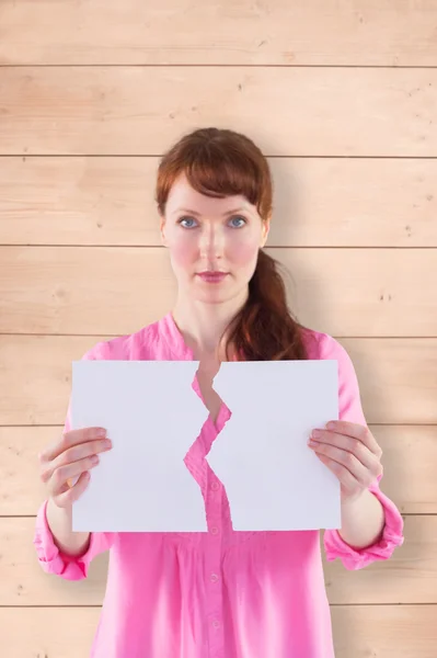 Woman holding torn sheet of paper — Stock Photo, Image