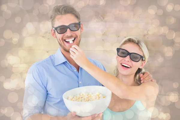 Couple wearing 3d glasses eating popcorn — Stock Photo, Image