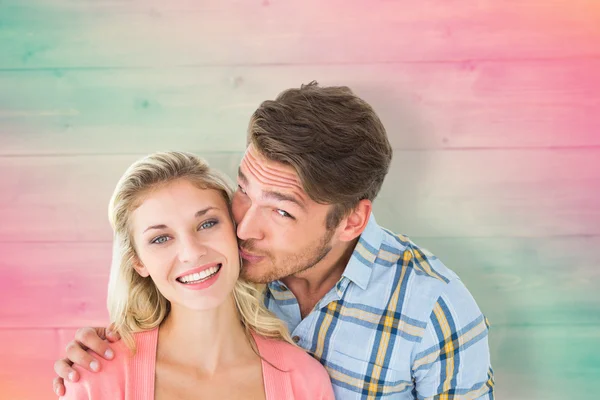 Handsome man kissing girlfriend on cheek — Stock Photo, Image