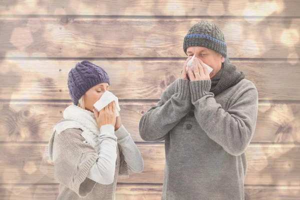 Sick mature couple blowing their noses — Stock Photo, Image