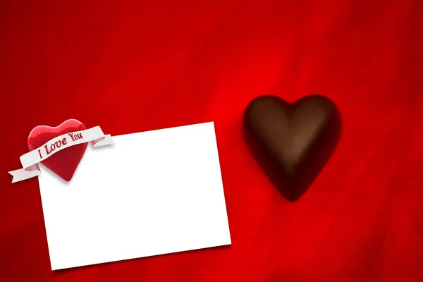 Chocolate heart against white card — Stock Photo, Image