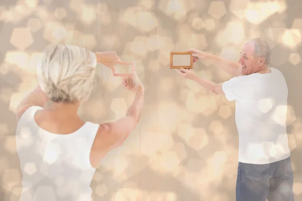 Couple hanging up picture frame — Stock Photo, Image