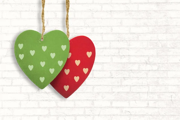 Hearts decorations against white wall — Stock Photo, Image