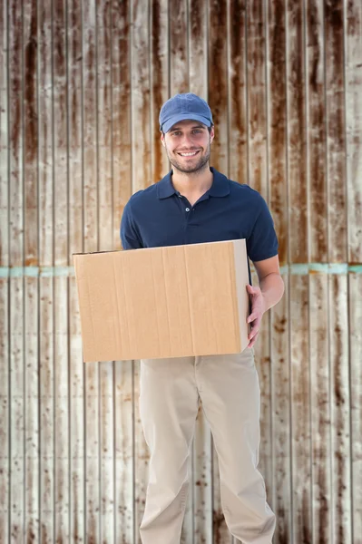 Delivery man holding cardboard box — Stock Photo, Image