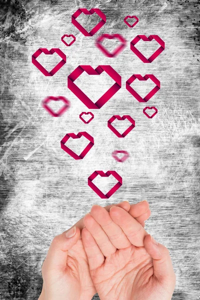 Hands presenting hearts — Stock Photo, Image