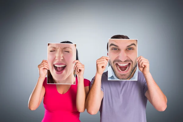 Cheering couple against grey vignette — Stock Photo, Image