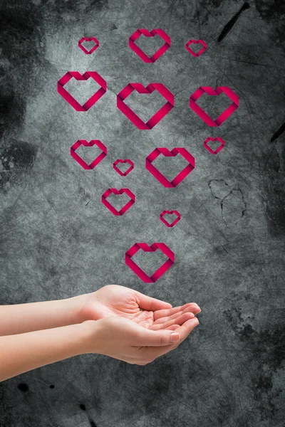 Hands presenting hearts — Stock Photo, Image