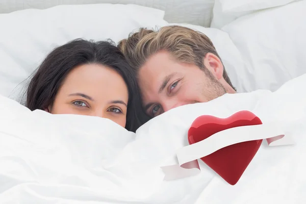 Paar versteckt sich unter der Bettdecke — Stockfoto