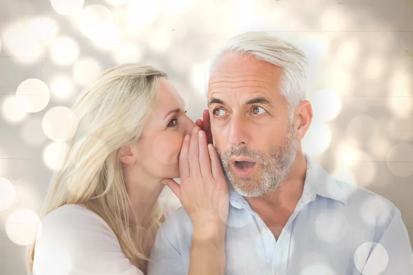 Woman whispering a secret to husband — Stok fotoğraf