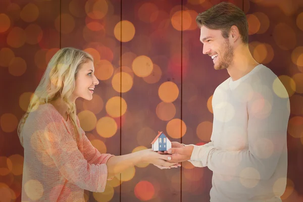 Couple holding miniature house model — Stock Photo, Image