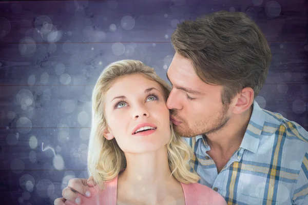 Handsome man kissing girlfriend on cheek — Stock Photo, Image