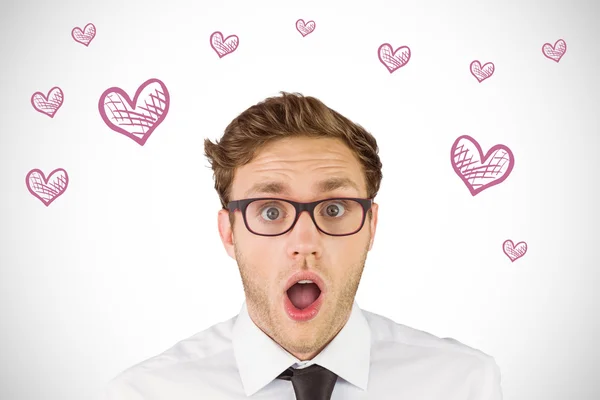 Businessman looking at camera against hearts — Stock Photo, Image