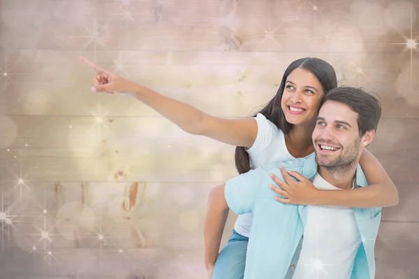 Man giving pretty girlfriend piggy back — Stock Photo, Image