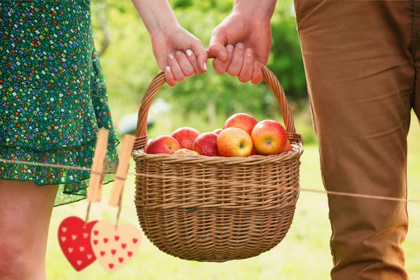 Apples being carried by a young couple — Stock Photo, Image