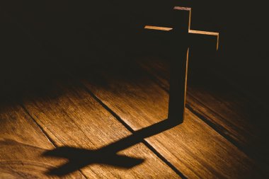 Crucifix icon on table in the shadow clipart