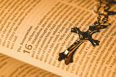 Open bible and silver crucifix clipart
