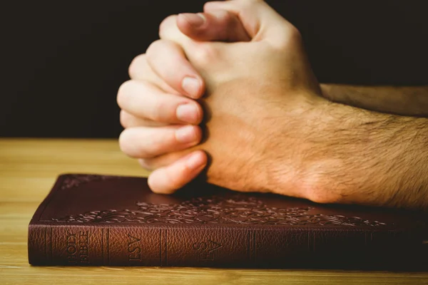 Man praying over his bible — Stock Photo, Image