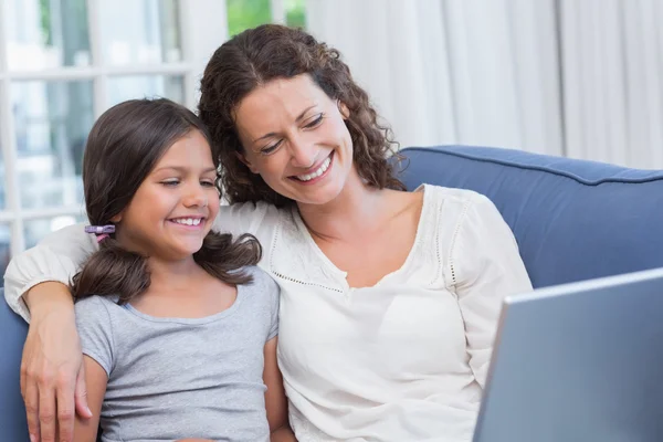 Feliz madre e hija usando el ordenador portátil — Foto de Stock