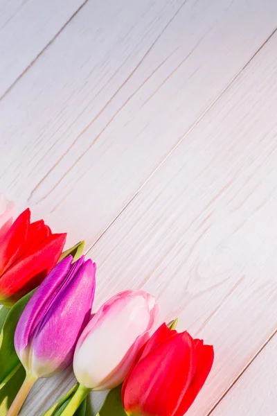 Tulips on wooden table — Stock Photo, Image