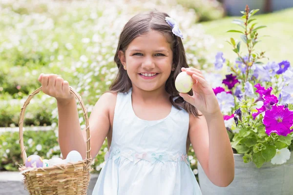 Happy girl collecting easter eggs — Stock Photo, Image