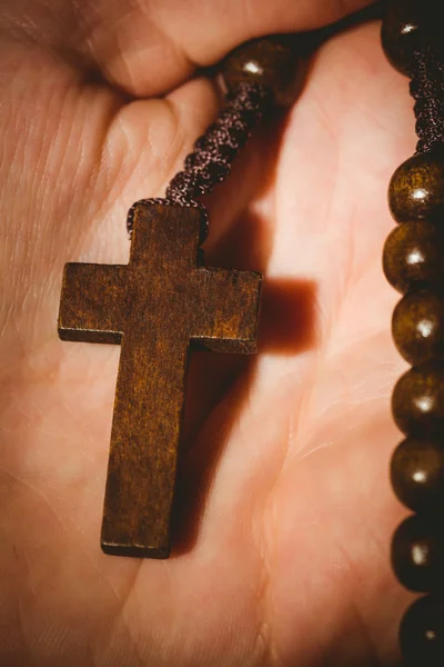 stock image Hand holding wooden rosary beads