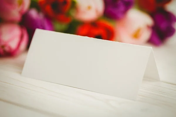 Colorful tulips and white card — Stock Photo, Image