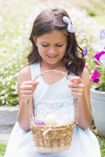 Happy girl collecting easter eggs — Stock Photo, Image