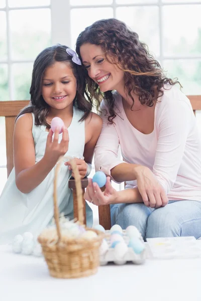 Happy mother and daughter holding easter eggs — Stock Photo, Image