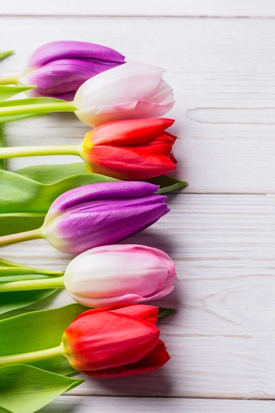 Tulips on wooden table — Stock Photo, Image