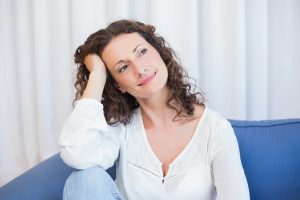Pretty brunette relaxing on the couch Royalty Free Stock Photos