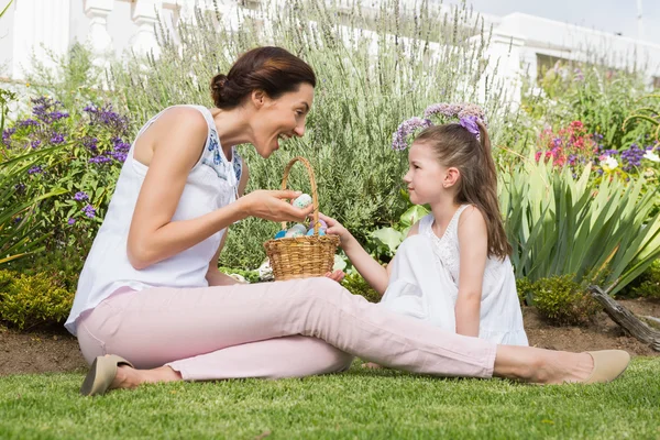 Mother and daughter collecting easter eggs Royalty Free Stock Photos