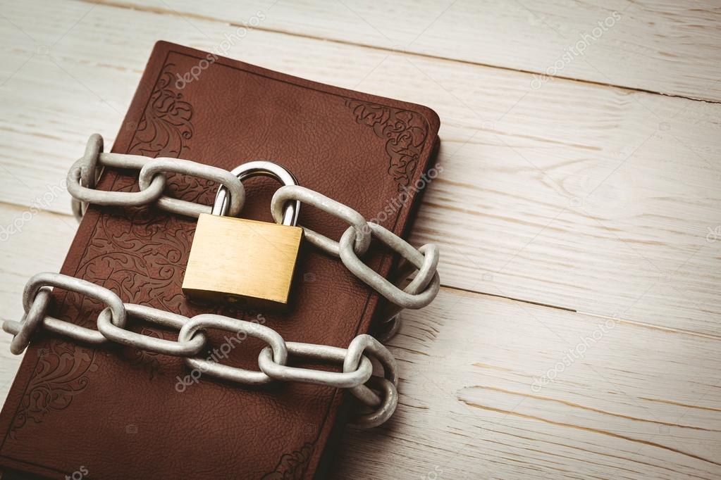 Open bible chained with lock Stock Photo by ©Wavebreakmedia 68955029