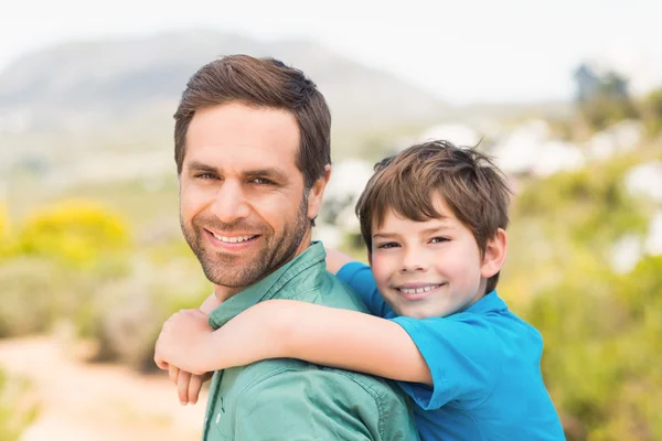 Father and son hiking through mountains — Stock Photo, Image