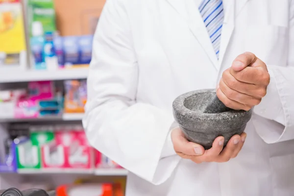 Pharmacist in lab coat mixing a medicine — Stock Photo, Image