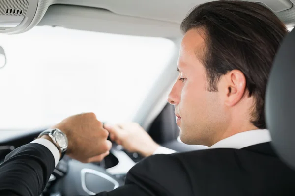 Businessman in the drivers seat — Stock Photo, Image