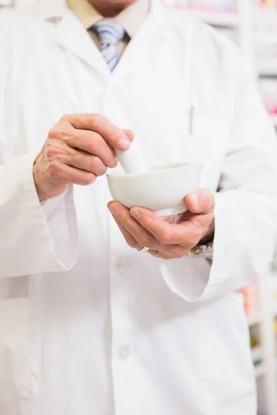 Mid section of pharmacist mixing medicine — Stock Photo, Image